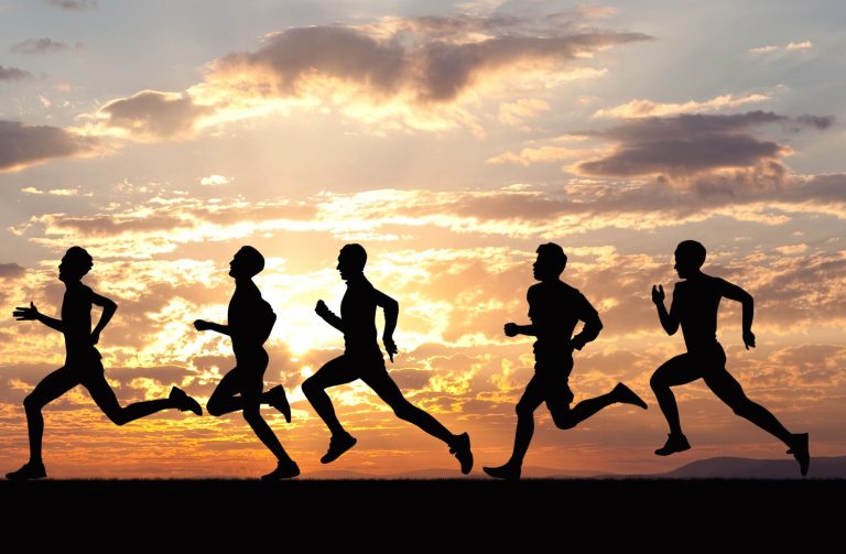 Marathon, black silhouettes of runners on the sunset